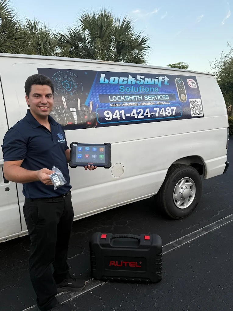 Carlos, Owner of Lockswift Solution LLC holding his Autel MaxiIM key programmer tablet next to his mobile locksmith van in Sarasota, FL